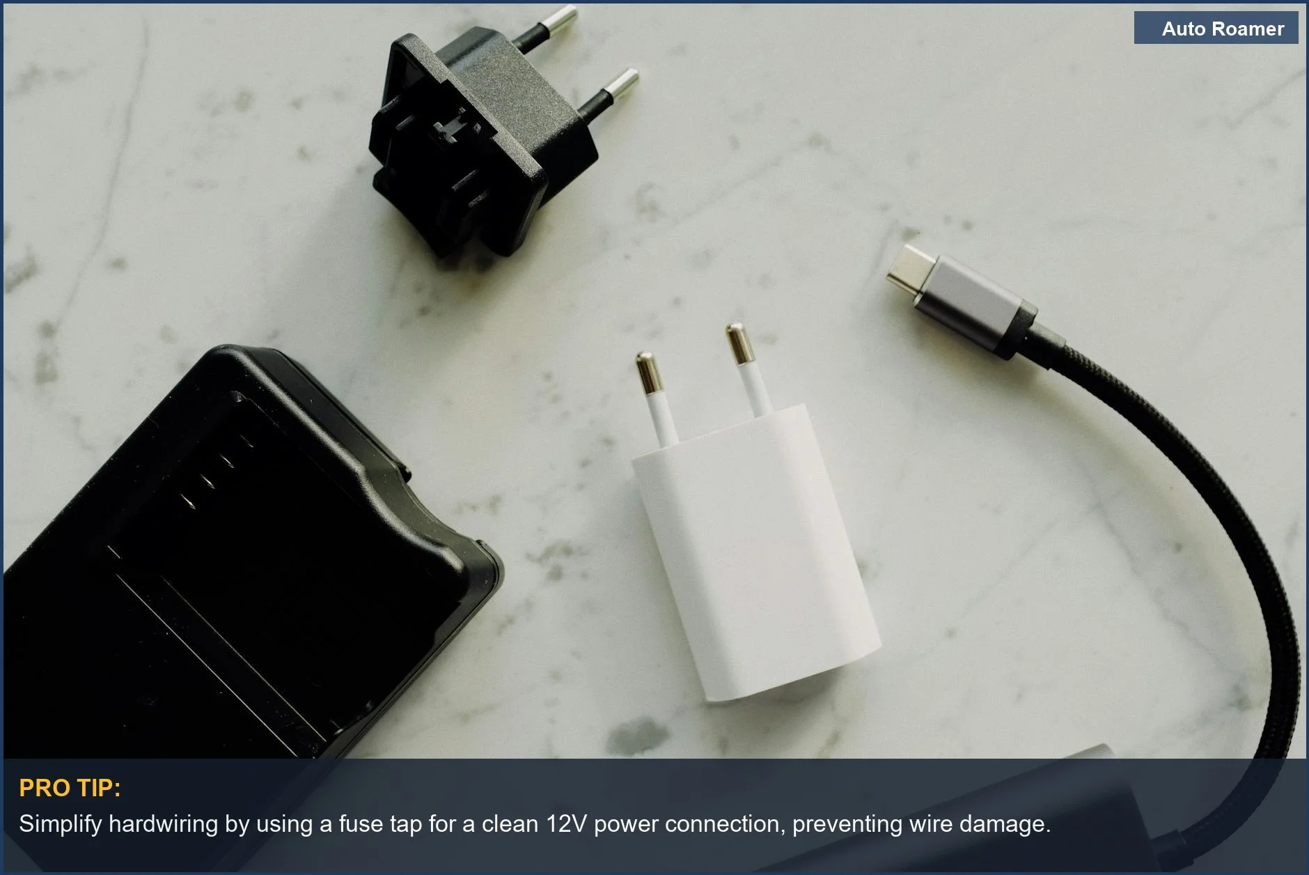 Flat lay of electronic adapters and chargers on a marble background, representing hardwiring camera power solutions.