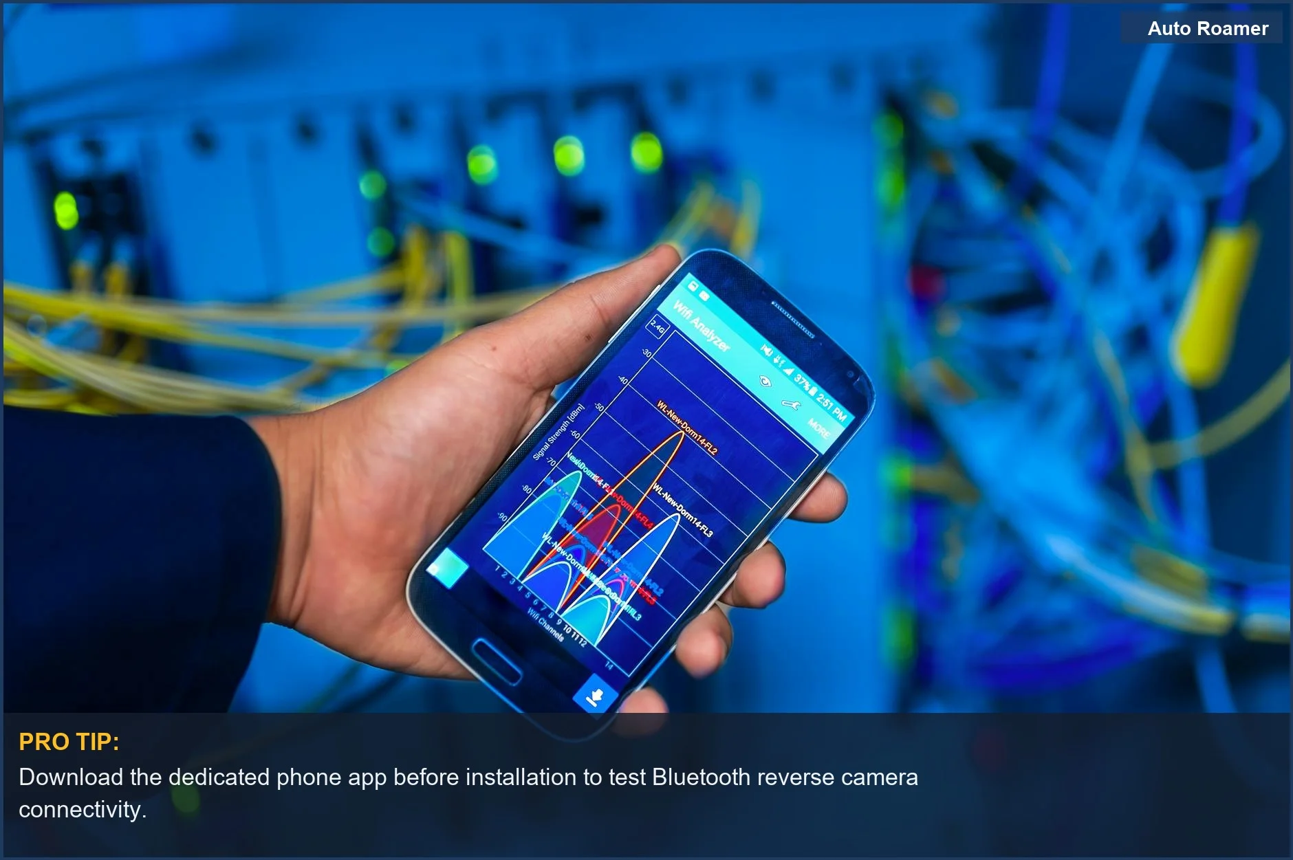 Hand holding smartphone showing network analysis, illustrating phone app control for Bluetooth reverse cameras.