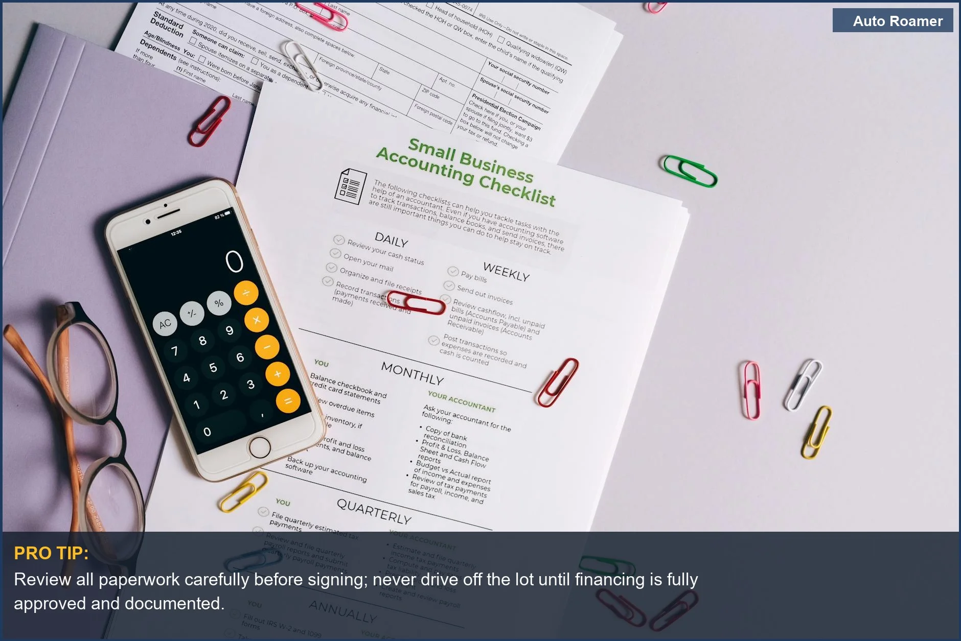 Desk with accounting essentials, smartphone, eyeglasses, and paperwork, illustrating the complexities of yo-yo financing scams.