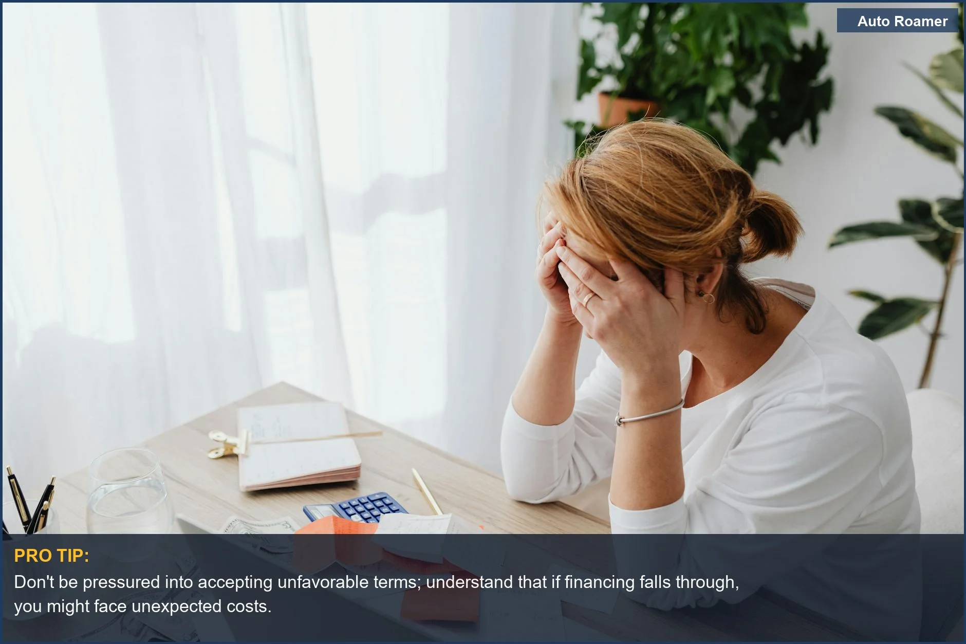 Stressed woman at desk with financial receipts and calculator, highlighting the financial burden of dealer called financing fell through.