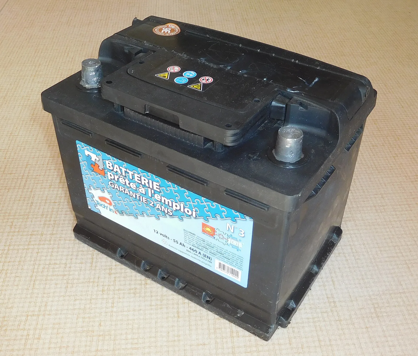 A 12-volt 55-amp-hour lead-acid car starter battery with its two terminal posts, the kind campers weigh adding as a second bank