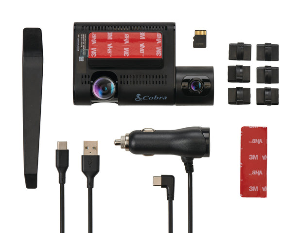 Dual-lens dash cam kit laid out with mounts, cables, trim tool and memory card
