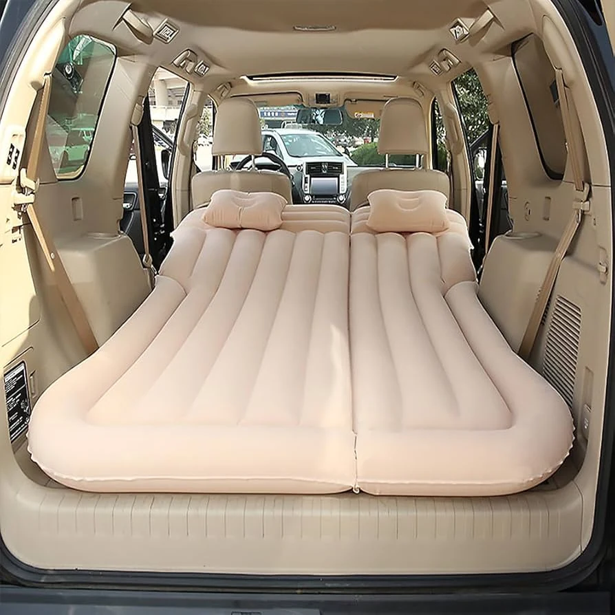 Inflatable car bed inflated across a folded-flat SUV cargo floor